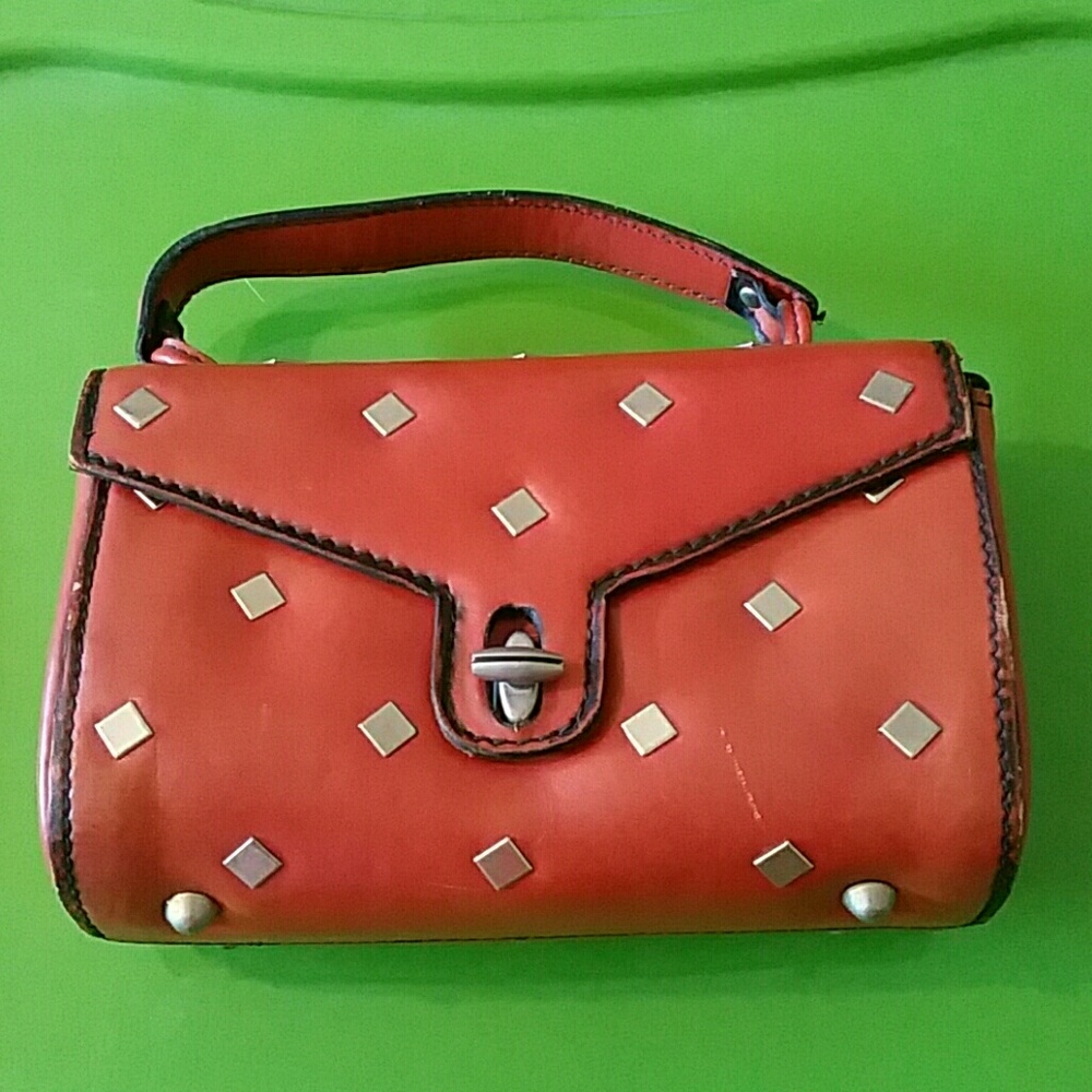 Brown handmade leather purse with metalstuds.